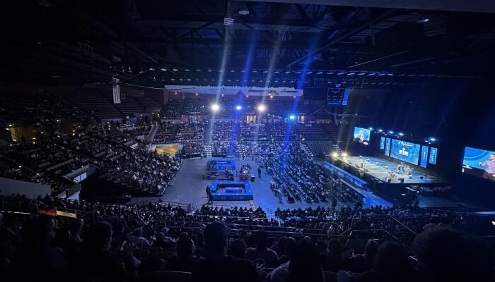 What is actually drawing people through the door | tycoonstory media Life surge event venue filled with attendees, stage lighting, and a large audience gathering for an inspiring live experience.
