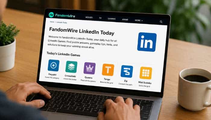 Linkedin games 1 | tycoonstory media Person typing on a laptop showing the fandomwire linkedin today page with a large linkedin logo and colorful game icons on the screen.