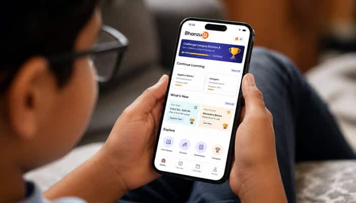 Main features of the bhanzu student app - tycoonstory | tycoonstory media Child using the bhanzu student app on a smartphone to access math lessons, course modules, class reminders, practice activities, ai-assisted learning features, and performance reports.