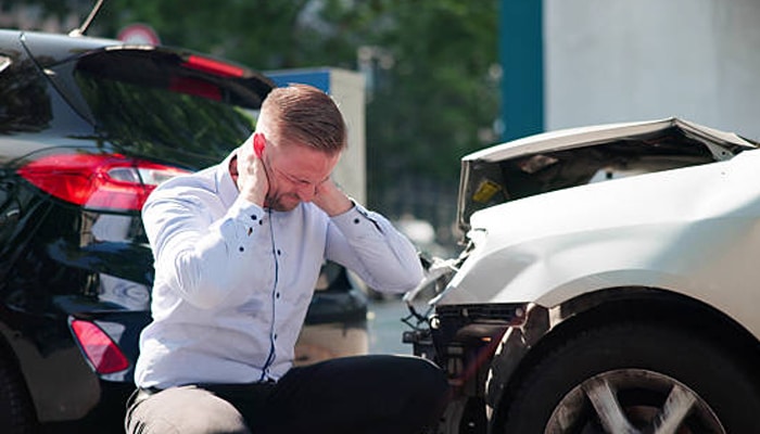 Personal attorney | tycoonstory media Personal injury claim after a car accident showing an injured driver seeking support and legal guidance