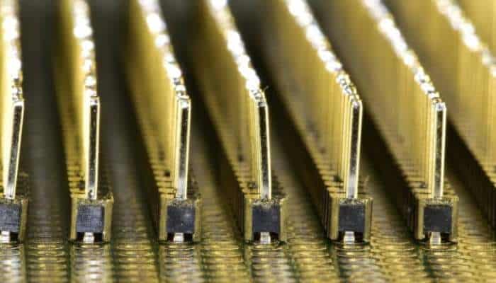Smt pogo pins | tycoonstory media Close-up of gold-plated keyboard switch contacts aligned in a row on a circuit board.