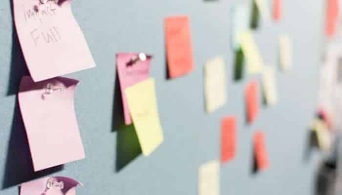 Startup customer support 1 | tycoonstory media Colorful sticky notes on a blue wall, suggesting a brainstorming or planning board.