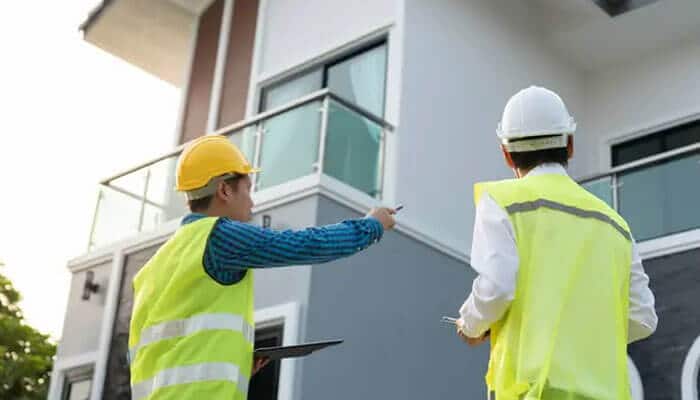 Building systems that prevent violations before they happen - tycoonstory | tycoonstory media Construction site safety inspection with engineers wearing ppe and reviewing building progress, emphasizing osha compliance, permit verification, hazard identification, quality control, and proactive site management to avoid stop-work orders.