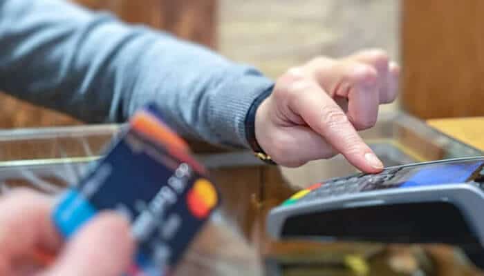 Durango merchant services - tycoonstory | tycoonstory media Customer making a secure card payment through a pos terminal powered by high risk payment processors, supporting credit cards, ach, echeck payments, fraud prevention, and reliable merchant account services.