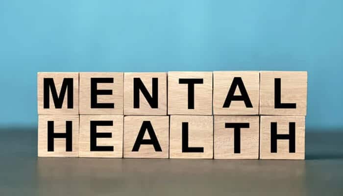 Mental health is interconnected | tycoonstory media Psychiatry emr platforms concept showing wooden blocks spelling “mental health,” representing how psychiatric emr systems integrate interconnected factors such as mood, diagnosis, medication, and social influences in holistic patient care.
