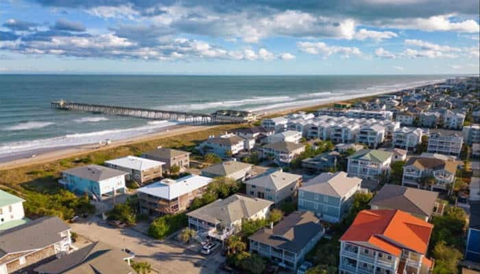 Population growth supports home prices - tycoonstory | tycoonstory media Aerial view of a coastal residential neighborhood demonstrating home values in myrtle beach, where proximity to the beach, community development, neighborhood desirability, and resale potential contribute to sustained property market growth.