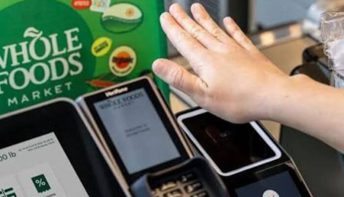 What happened to amazon one at whole foods market 1 | tycoonstory media Amazon one service discontinuation at whole foods market showing a customer using the amazon one palm scanner before the biometric payment service ended in 2026.