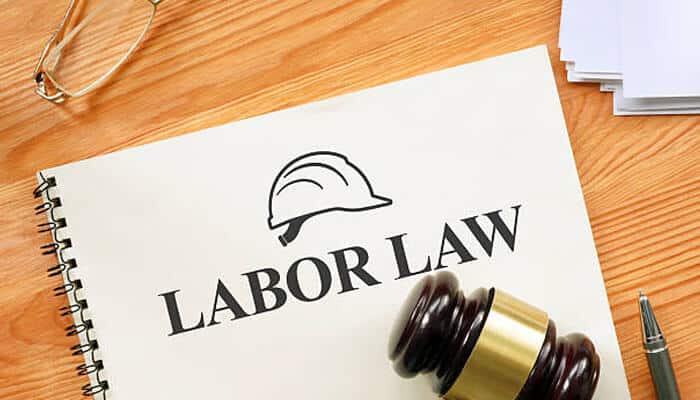 Employer responsibilities under the law | tycoonstory media Labor law 240 concept shown with a legal gavel, hard hat symbol, and labor law document representing construction worker protections.