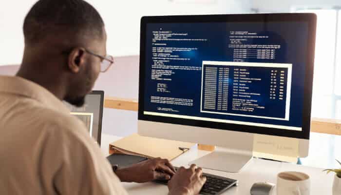 Github copilot best for ai-assisted development - tycoonstory | tycoonstory media Latest online tool guide zardgadjets showing a developer using ai-assisted coding tools and source code on a desktop monitor.