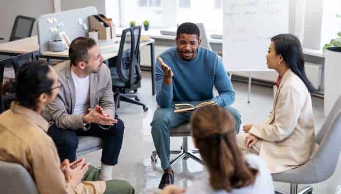 Proven strategies for overcoming complex sales objections 1 | tycoonstory media Sales team discussing buyer concerns during a meeting, demonstrating strategies for handling complex sales objections through collaboration and communication.