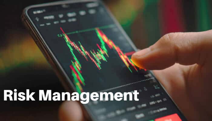 Risk management - tycoonstory | tycoonstory media Cryptopronetwork adrian risk management concept showing a trader analyzing volatile cryptocurrency price charts on a smartphone to assess market movements and trading risk.