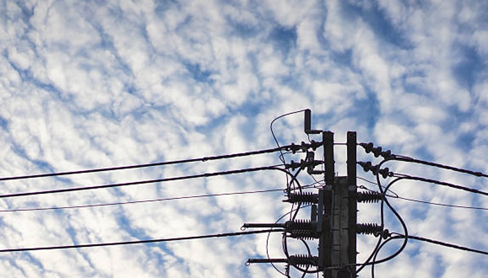 Untitled-1 | tycoonstory media Grid congestion represented by crowded power lines and electrical infrastructure carrying electricity across a constrained distribution network.