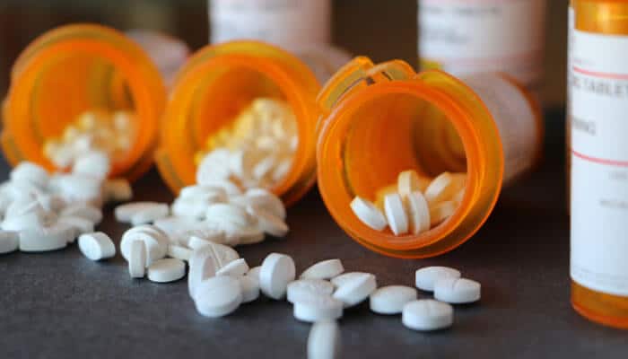 Who should avoid or use the bi 8 white pill with extra caution - tycoonstory | tycoonstory media Bi 8 white pill prescription ibuprofen 800 mg represented by white tablets spilling from orange pharmacy bottles, highlighting medication safety and cautious use.