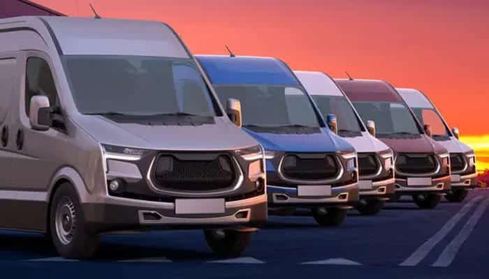 Choosing the right materials - tycoonstory | tycoonstory media Line of white delivery vans lined up along a road at sunset with a warm orange sky.