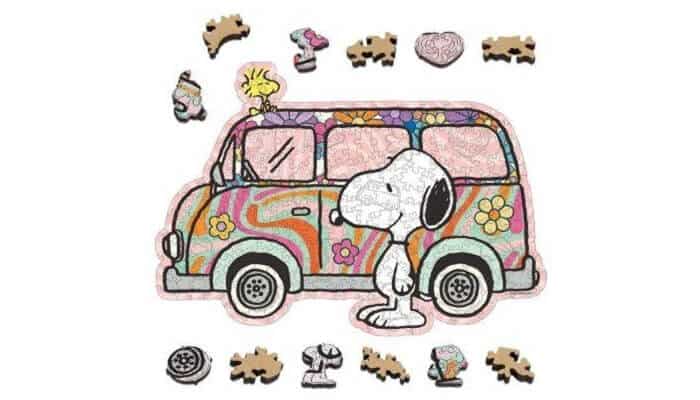 Put together a puzzle | tycoonstory media Colorful cartoon van with snoopy in front, woodstock on the roof, and puzzle pieces scattered around.