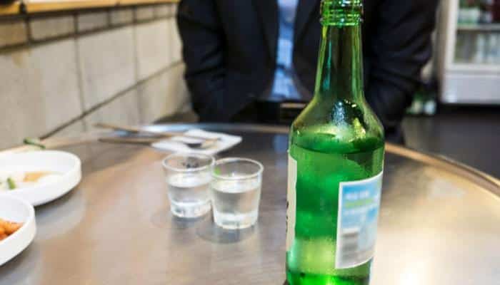 How many shots are in one bottle of soju - tycoonstory | tycoonstory media Soju alcohol content shown with a chilled green soju bottle and two traditional shot glasses on a korean restaurant table, illustrating typical 360 ml bottle servings and abv.