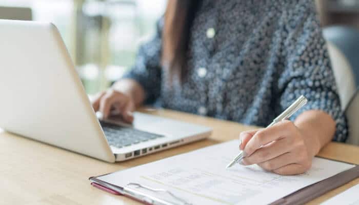 How to check iowa business name availability - tycoonstory | tycoonstory media Iowa secretary of state business search process showing a business owner reviewing documents and checking iowa llc and corporation name availability, entity records, registration details, and company information online