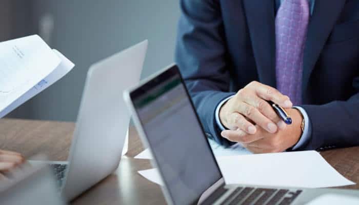 How to get an illinois certificate of good standing - tycoonstory | tycoonstory media Illinois business entity search process showing a business professional reviewing company documents and digital records to verify llc and corporation information, check entity status, and obtain an illinois certificate of good standing through official state business services.
