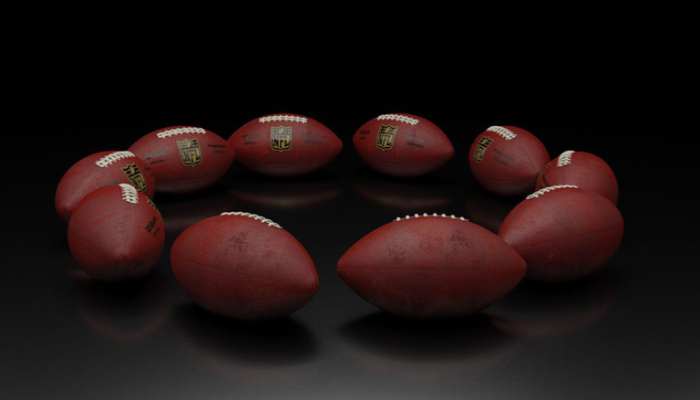 Real-money online casino games 1 | tycoonstory media Red american footballs arranged in a ring on a dark, reflective surface.