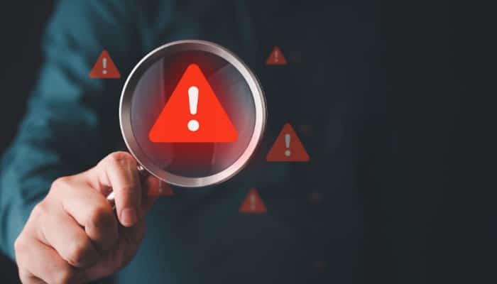 Red flags that deserve attention - tycoonstory | tycoonstory media Netdesizn com red flag analysis concept showing a warning symbol under a magnifying glass, representing website review, online safety checks, digital service verification, and evaluation of potential risks before using web design or marketing platforms.