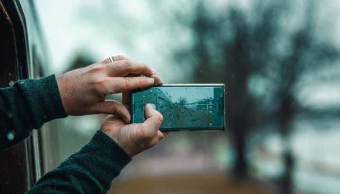 Smarter mobile devices - tycoonstory | tycoonstory media What tech came out in 2022 jotechgeeks image showing a person using a smartphone camera, representing smarter mobile devices, computational photography, ai-powered cameras, 5g connectivity, and mobile innovation in 2022.