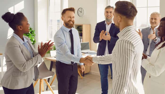 Strengthen employee recognition - tycoonstory | tycoonstory media Inspirational quotes for work showing a diverse team celebrating employee recognition, workplace appreciation, teamwork, and professional achievement in a modern office environment.