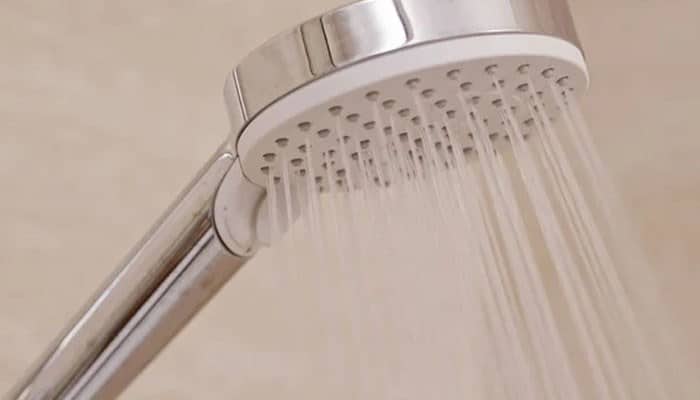 A problem with the shower valve | tycoonstory media Shower water pressure example showing a showerhead with steady water flow and modern bathroom fixtures for improved performance.