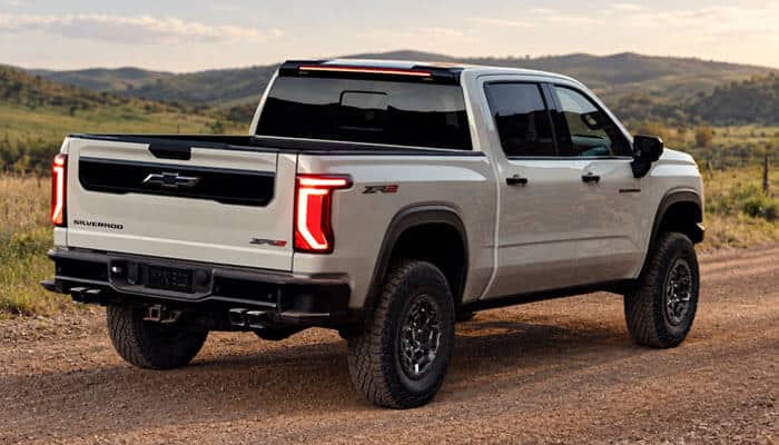 Which 2027 chevy silverado trim should you buy? - tycoonstory | tycoonstory media 2027 chevy silverado zr2 rear view showing off-road design, rugged tires, updated tailgate styling, advanced suspension features, and enhanced capability for adventure and work.