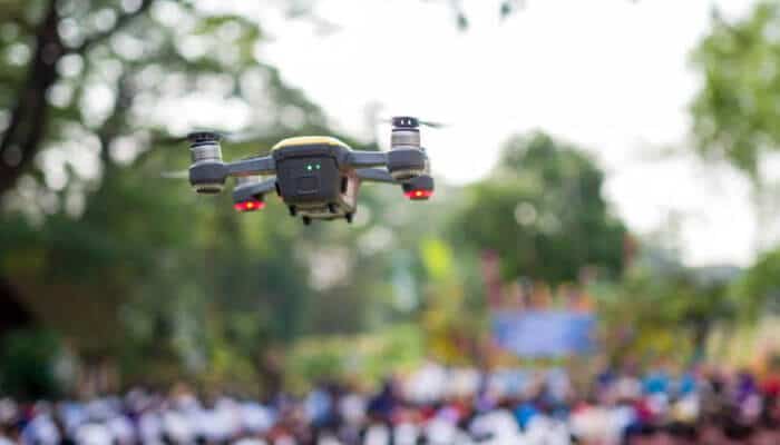 Add new perspectives to event coverage | tycoonstory media Quadcopter drone hovering over a crowd at an outdoor event