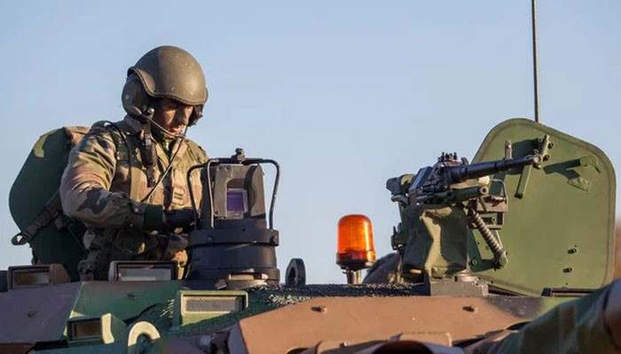 Communications and specialist equipment - tycoonstory | tycoonstory media Plasan jeep gladiator combat vehicle tactical equipment featuring a soldier operating a communication system beside a shielded mounted machine gun.