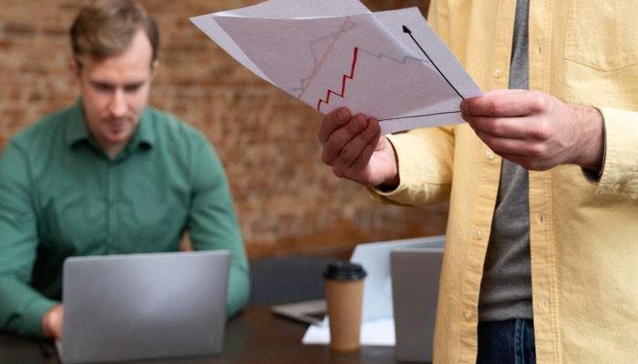 Does a lower employee count mean target is struggling - tycoonstory | tycoonstory media Business professionals reviewing workforce trend charts, illustrating "about how many employees does target corporation employ? " and staffing changes.