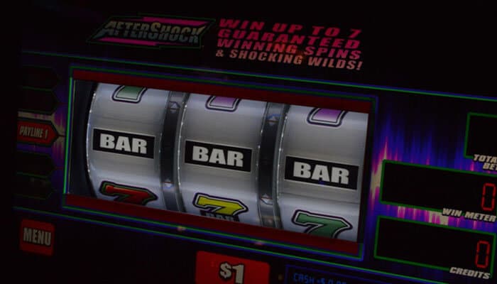 Crown sites and offshore operators | tycoonstory media Three-reel slot machine showing bar symbols with neon lighting and colorful cabinetry.