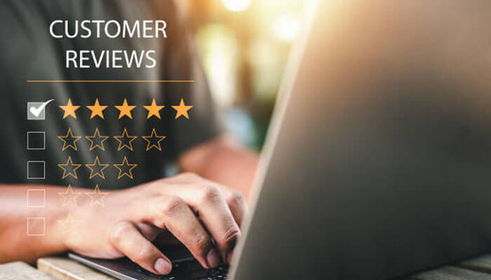 Product air's customer reviews | tycoonstory media Customer reviews header with a hand on a laptop keyboard and a highlighted five-star rating.
