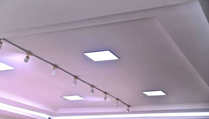Choose the appropriate led density | tycoonstory media Ceiling with square recessed lights and a track lighting rail with small spotlights.