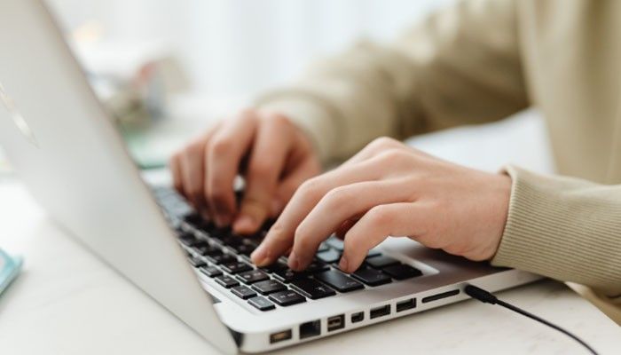 Is a captcha response a security guarantee - tycoonstory | tycoonstory media What is a captcha challenge response illustrated by a person typing on a laptop, representing how user interactions can trigger captcha verification and generate response data for server-side validation.