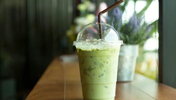 It can replace a sugary drink - tycoonstory | tycoonstory media What is matcha shown as a refreshing iced matcha latte made with finely powdered green tea, milk, ice, and a straw in a café setting.