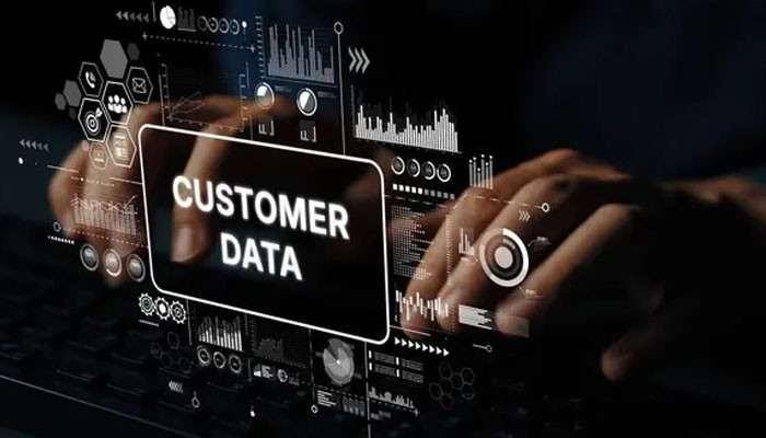 Customer data is fragmented | tycoonstory media Hands typing over a translucent screen labeled 'customer data' with holographic data visuals surrounding it.