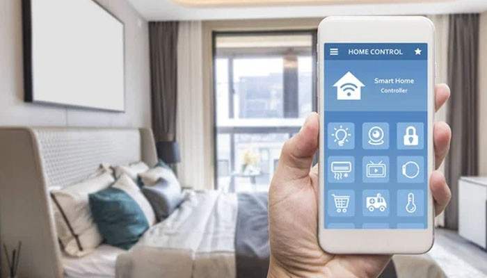 Smart energy monitoring - tycoonstory | tycoonstory media Techoelite smart homes smartphone interface displaying smart lighting, security, temperature, and connected device controls in a modern bedroom.