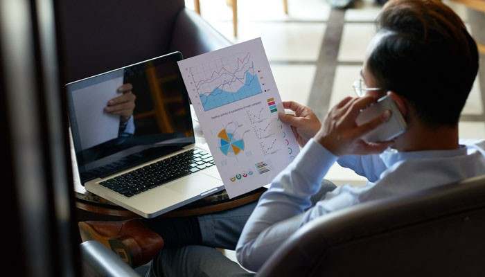 Turn marketing traffic into customers - tycoonstory | tycoonstory media Robthecoins business tips showing a business professional reviewing marketing analytics, conversion charts, and performance data during a virtual meeting.