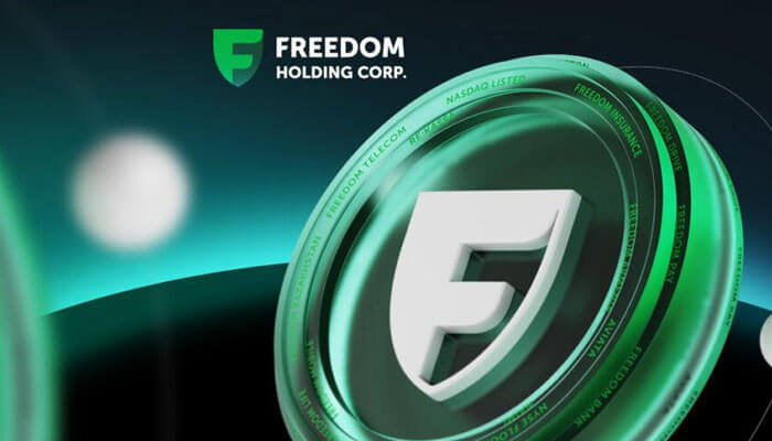 Superapp | tycoonstory media Freedom holding corp branding image featuring a green shield logo and circular emblem on a teal gradient background.