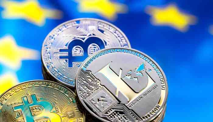 What happens in each type of wallet transfer | tycoonstory media Close-up of crypto coins (bitcoin, ethereum, litecoin) stacked against a blurred blue background with yellow stars.